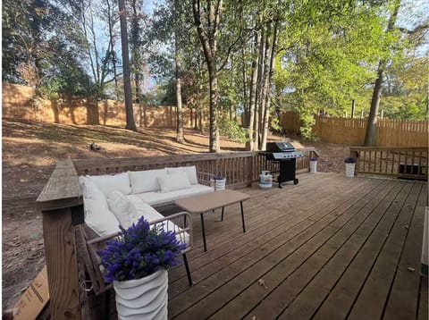 Spacious backyard with outdoor couch, grill and open-air perfect for relaxing