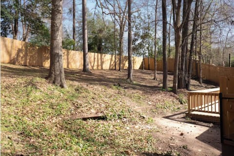 Spacious backyard with outdoor couch, grill and open-air perfect for relaxing