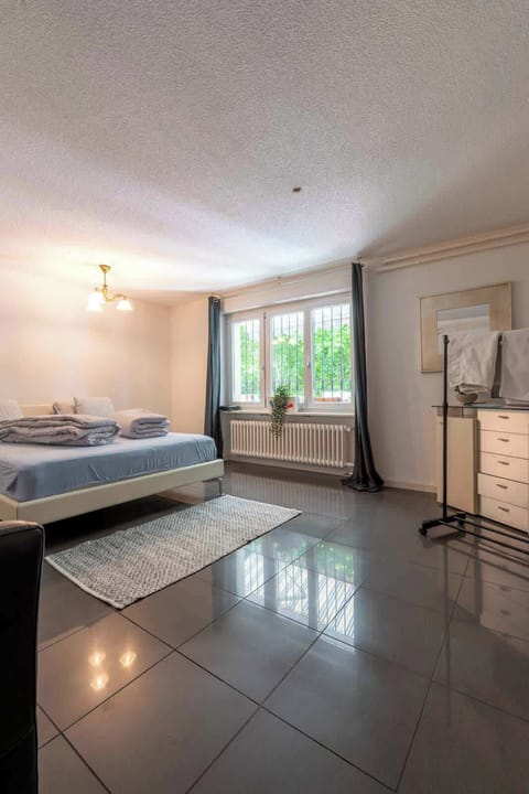 Spacious king bedroom with large window and natural light