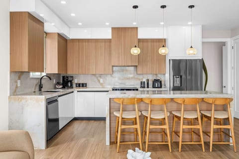 Stylish kitchen island with seating for the whole crew, perfect for morning coffee or casual meals between beach adventures.