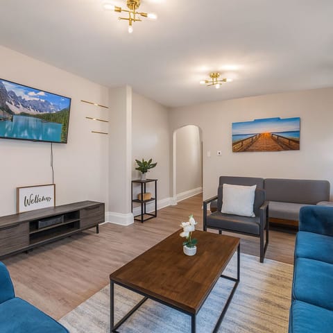 Bright and spacious living room with a comfy sofa and a smart TV for Netflix nights.