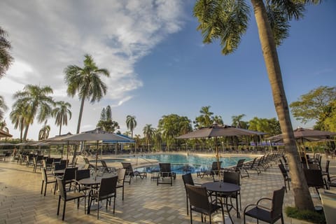Sip and socialize under umbrellas with pool views all day.