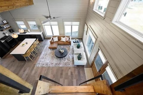 Loft view of modern open layout featuring cozy seating 
