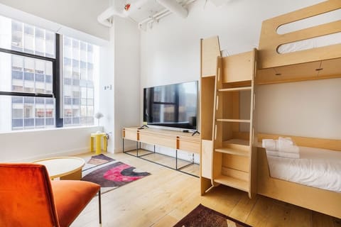 Gather everyone in the bright room with comfy bunk beds.