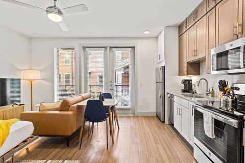 Cook and sip coffee in a sunlit, modern open kitchen.