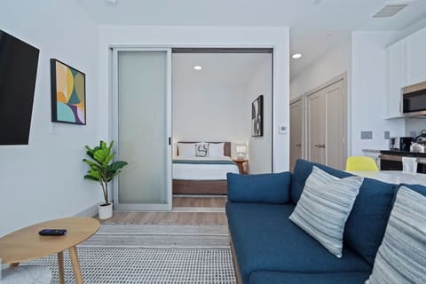 Unwind in a bright, modern bedroom behind sleek sliding doors.
