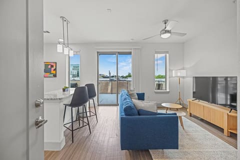 Step into airy open-plan living flowing onto the balcony.