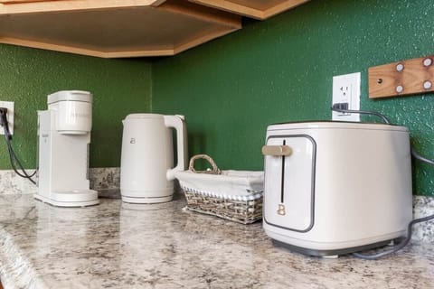 Keurig machine, water kettle, toaster, assorted coffee pods, tea and hot cocoa.