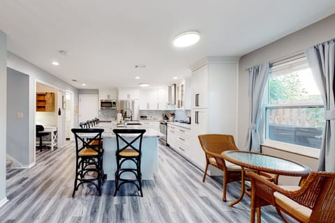 Extra dining table seats two along with large breakfast bar island seating six