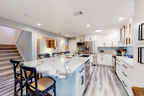 Sleek & modern kitchen with kitchen island that seats six