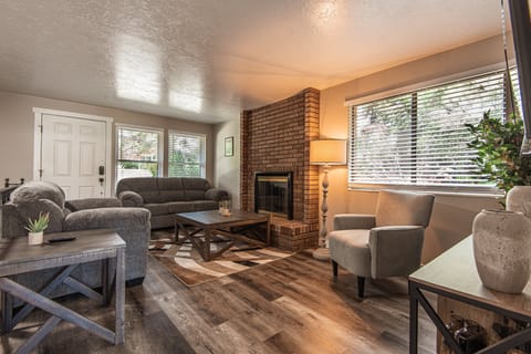 Spacious living room with cozy fireplace, smart TV, comfortable seating for the whole group, and stunning mountain views.