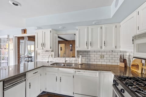 Willow on the Pond - Functional kitchen with a pass-through above the sink, ideal for connecting spaces while cooking.