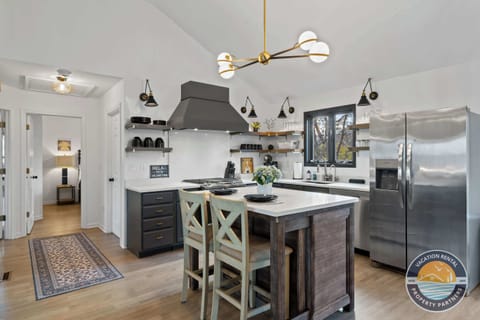 Airy, open-concept kitchen flooded with natural light - spacious layout flows seamlessly into living and dining areas