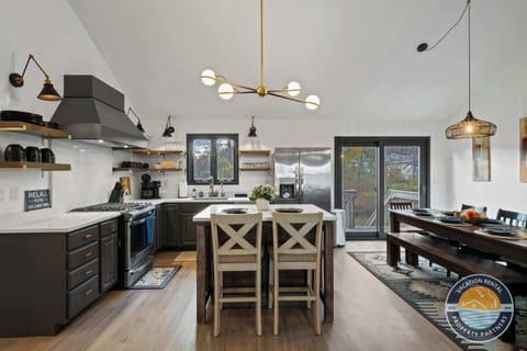 Modern, fully-stocked kitchen with stainless appliances, large island with bar seating, and everything you need to cook