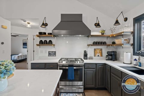 Bright kitchen with coffee bar and modern appliances - gather here for morning coffee and meal preparation together