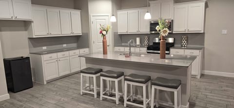 Full open kitchen with 4 bar stools for breakfast area and a large island