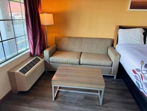 Lounge by the window with cool air and soft seating.