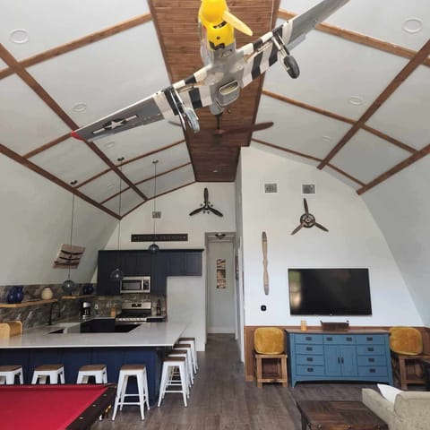 Soar high in style with an airplane-themed retreat and a spacious kitchen for gatherings!