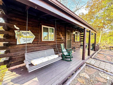 Rocking chairs and a swing overlooking peaceful wooded surroundings.