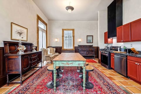 Fully equipped kitchen with modern appliances, vintage cabinetry, and a large rustic island ideal for cooking and gathering.