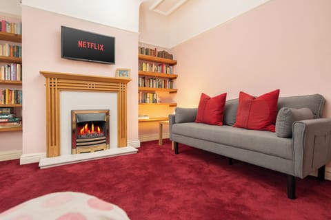 Step into a warm and welcoming living room designed for comfort and connection. Sink into one of the two plush sofas by the fireplace, enjoy a film on the Smart TV, or unwind with a board game or a good book from the cosy in-house library.