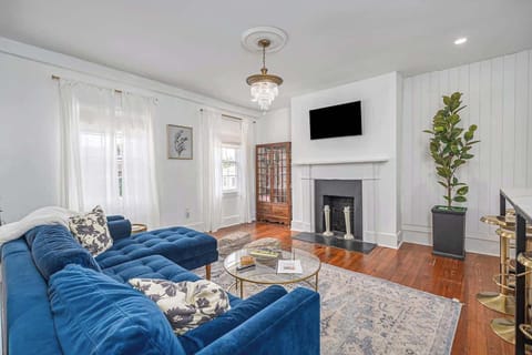 Bright, open, and full of charm. This modern living room blends crisp white walls with a bold blue sofa for the perfect balance of comfort and style.