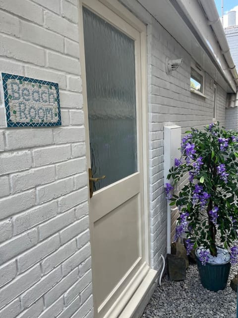 Private entrance by the lilac bush