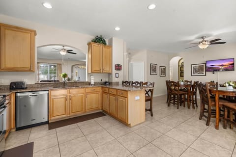Fully stocked kitchen leads to dining area - Magical Memories