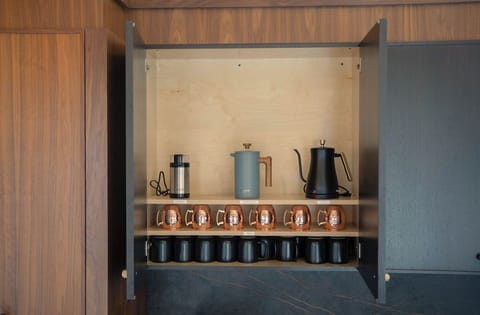 Fully stocked coffee bar with drip, French press, and pour-over options — a morning essential for early risers.