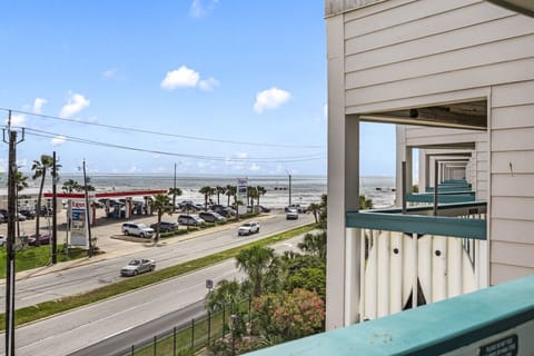 Private 3rd-floor balcony at Condo #327 offering coastal breezes and a lively Seawall view.