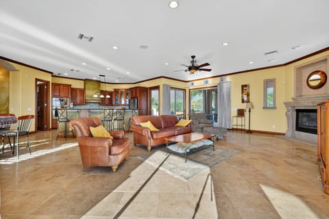 Expansive living room and kitchen with open-concept design and bright