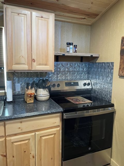 Full size stovetop oven provided along with pots and pans