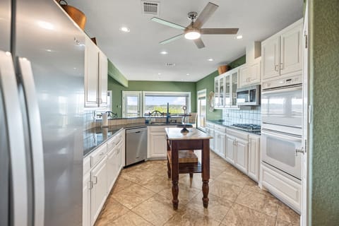 Fully equipped kitchen on the main entry level with full-size appliances, cookware, and essentials for family meals.