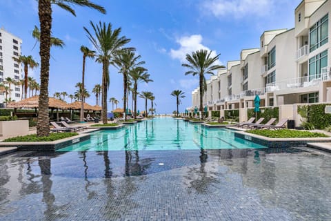 Relax in luxury at Sapphire's iconic resort style pool surrounded by palm trees, cabanas, and endless sunshine.