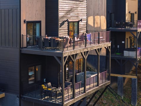 Spacious main-level deck with dining, lounge seating, and games—perfect for golden-hour hangs.