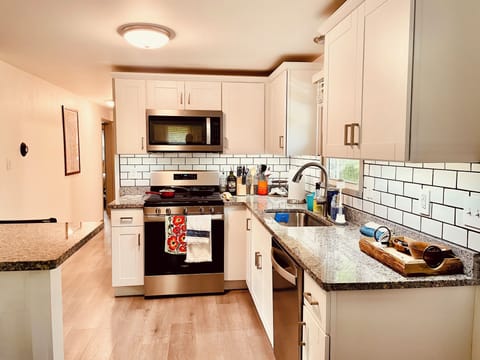 Fully stocked kitchen, stove, microwave, dishwasher.