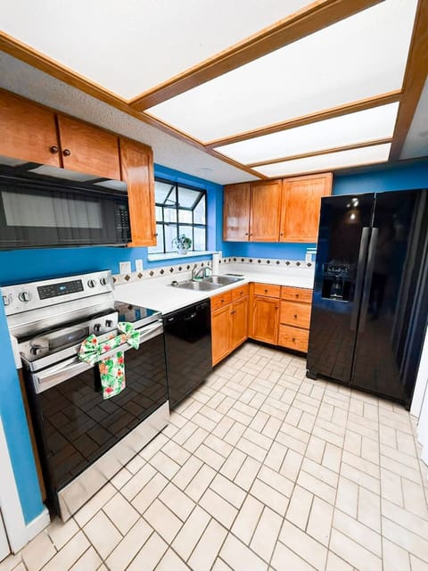 Fully equipped kitchen with modern appliances and a cheerful blue theme.