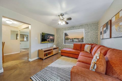 MAIN HOUSE: Stylish living room space with plenty of comfortable seating and smart TV — perfect for restful evenings