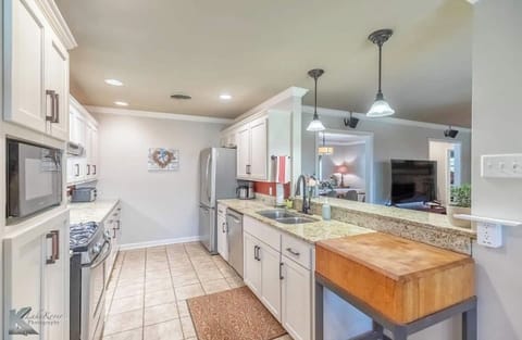 Our kitchen is stocked with dishes, silverware, baking sheets, and even wine glasses for those special moments