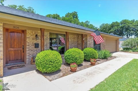 Step outside to a beautifully landscaped exterior filled with lush greenery.