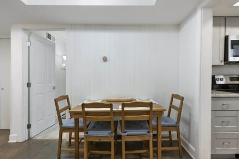 Cozy dining area with seating for four, featuring simple wooden furniture and a bright, minimalist design.