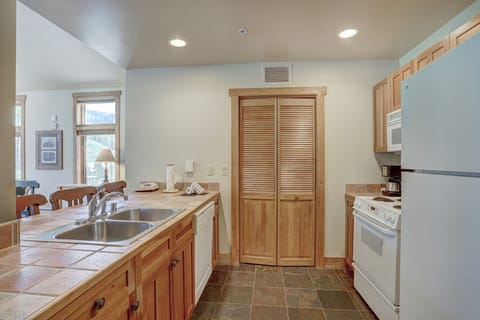 The kitchen’s open layout and stone flooring combine rustic charm with modern convenience.