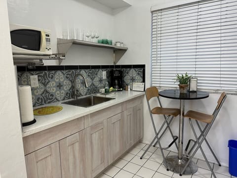 Kitchen with granite counter top and tile backsplash, Microwave, refrigerator with
gas stove and oven.