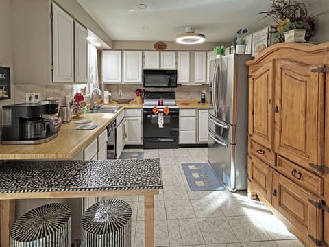 Fully equipped kitchen with modern appliances and rustic charm.