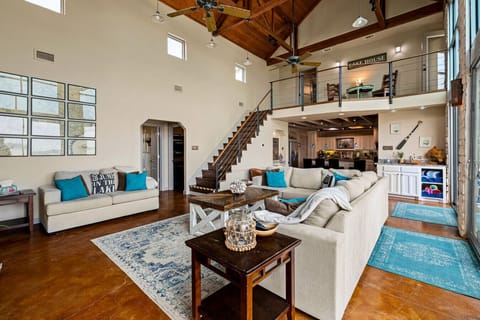 Living Room| Vaulted Ceilings | Floor-to-Ceiling Windows | Open Loft & Lake Views