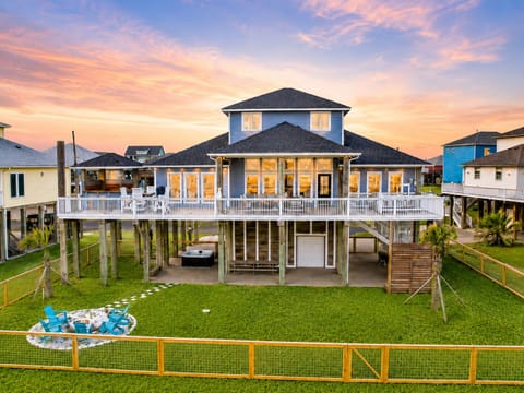 Stunning beachfront vacation home in Crystal Beach, Bolivar Peninsula with expansive ocean views, elevated deck, and spacious outdoor area perfect for large group getaways.