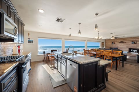 The open concept living areas with wall to wall windows showcase the endless views