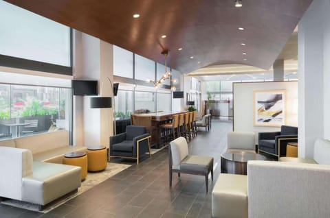 Lobby seating with sofas, chairs, and bright window lighting