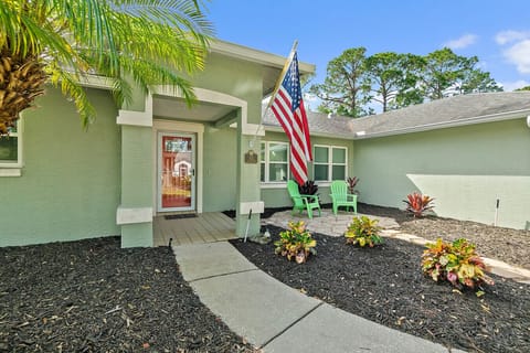 Welcoming front entrance with tropical landscaping
