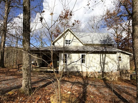 Our cottage is nestled in the woods  with water views from the back porch.  